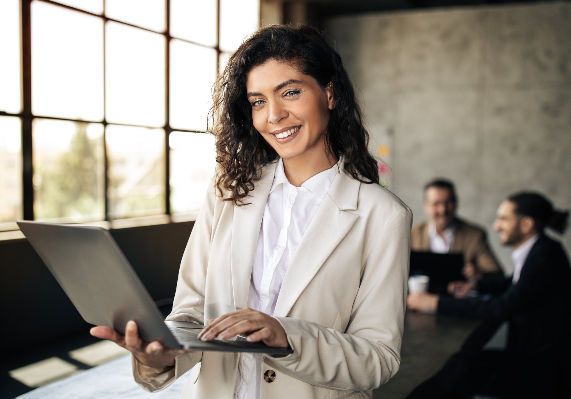 young-businesswoman-with-laptop-standing-near-cowo-2025-03-18-18-18-46-utc young-businesswoman-with-laptop-standing-near-cowo-2025-03-18-18-18-46-utc